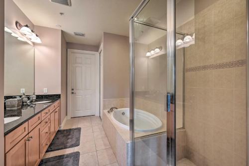 a bathroom with a tub and a glass shower at Naples Resort Townhome with Endless Amenities! in Lely Resort