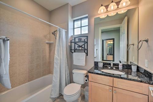 a bathroom with a toilet and a sink and a tub at Naples Resort Townhome with Endless Amenities! in Lely Resort