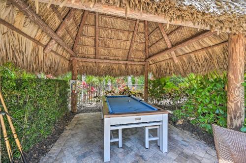 a pool table in a straw pavilion at Naples Resort Townhome with Endless Amenities! in Lely Resort