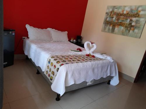 a bedroom with a bed with a white comforter at Millenium Manuel Antonio Park and beach in Manuel Antonio