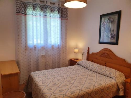 a bedroom with a bed and a window at Apartamento Maladeta in Torla-Ordesa