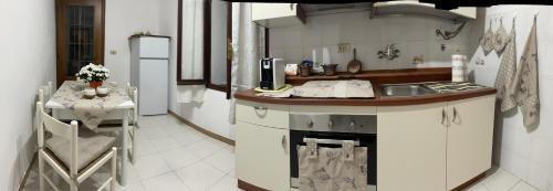 a kitchen with a sink and a counter with a table at Casa di nonno Memé CITRA 008035-LT-0018 in Andagna