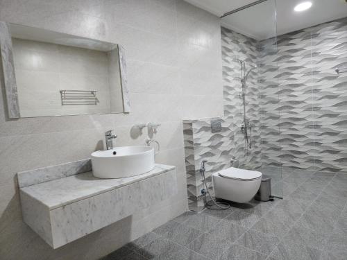 a bathroom with a sink and a toilet at Imperial Suites Hotel in Manama