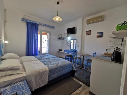 a bedroom with a bed and a desk in it at Anthis Studios in Pythagoreio