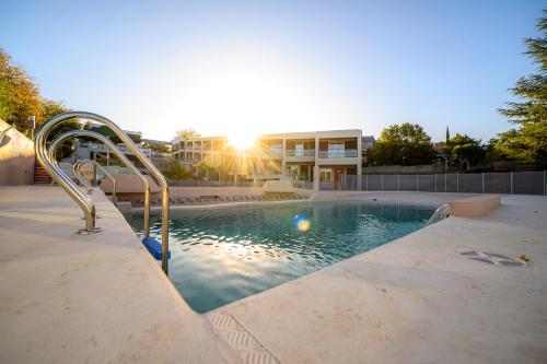 a swimming pool with a slide in front of a building at Estrella de Mar in Villa Carlos Paz