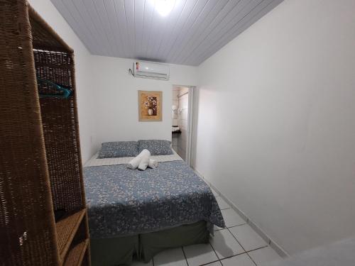 a small bedroom with a bed with a stuffed animal on it at Pousada Água Viva in Fernando de Noronha