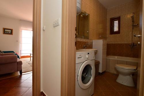 a bathroom with a washing machine in a bathroom at Mio Lux in Baošići