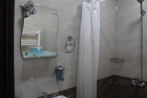 a bathroom with a shower with a shower curtain at Hotel Rabati in Akhaltsikhe