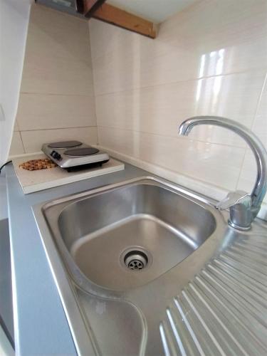 a kitchen sink with a faucet on a counter at Ahmeti Rooms in Ksamil