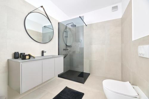 a bathroom with a toilet and a sink and a mirror at Apartments Dolcea in Umag