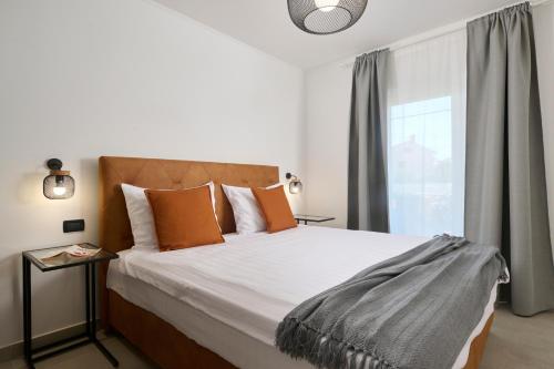 En eller flere senge i et værelse på Apartments Dolcea