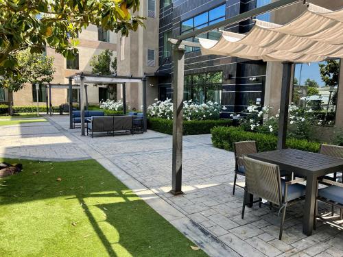 a patio with a table and chairs and a building at Staybridge Suites Carlsbad/San Diego by IHG in Carlsbad