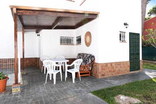 a patio with a table and chairs under awning at Poniente in Roche