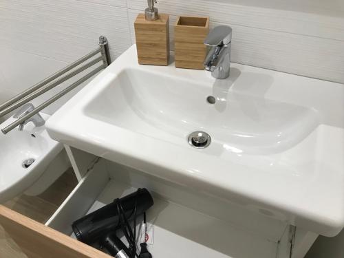 a white sink in a bathroom next to a toilet at Chioggia House di Marco in Chioggia