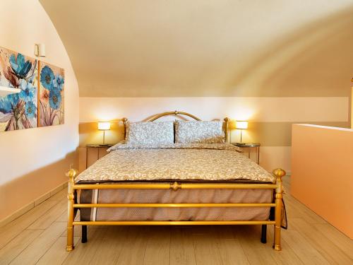 a bedroom with a bed with blue pillows at La Mia Dolce Vita in Calvagese della Riviera