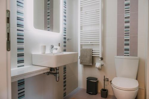 a bathroom with a white sink and a toilet at Nafplio Pleasure Stay II in Nafplio