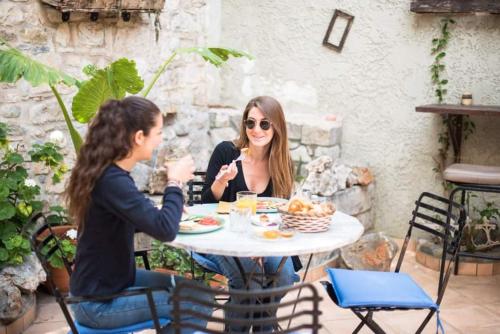 two women sitting at a table eating food at Ntouana hotel in Kalamata