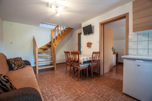 a living room with a table and a staircase at Bohinj Star Apartments in Bohinj