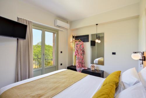 a bedroom with a large bed and a window at Dandelion apartments in Chania Town