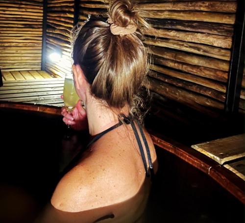 a woman in a bath tub holding a drink at Hotel El Milagro in Pisco Elqui