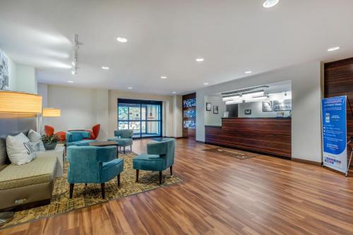 a lobby with a couch and chairs and a table at MainStay Suites St Louis Airport in Bridgeton