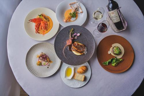 a white table with plates of food on it at Harmonie Embrassee in Osaka