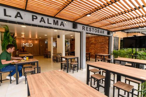 
a restaurant with tables, chairs, and tables at Med la palma in Medellín
