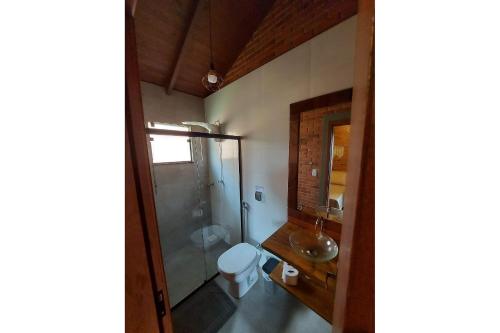 une salle de bains avec douche, toilettes et lavabo dans l'établissement Villa da Serra chalé Ibitipoca - 700m do centrinho, à Conceição da Ibitipoca