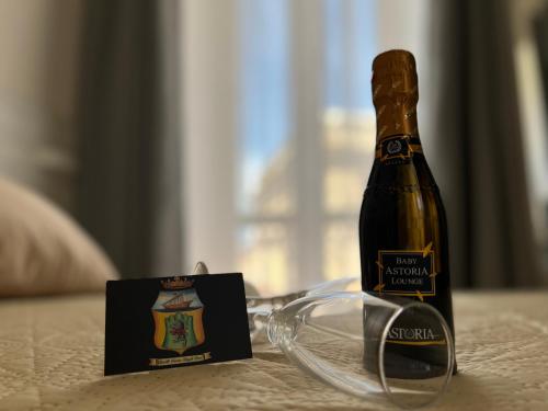 a bottle of champagne and glasses on a table at B&B Costa degli Dei in Tropea