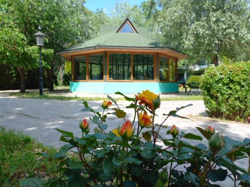 a gazebo in a park with a flower at Garni Lupus prenoćište in Kanjiža