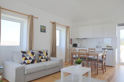 a living room with a couch and a table at House Nobrega of Madeira in Arco da Calheta