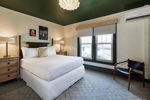 a bedroom with a large white bed and a window at The Whitlock by The Lenox Collection in Lenox