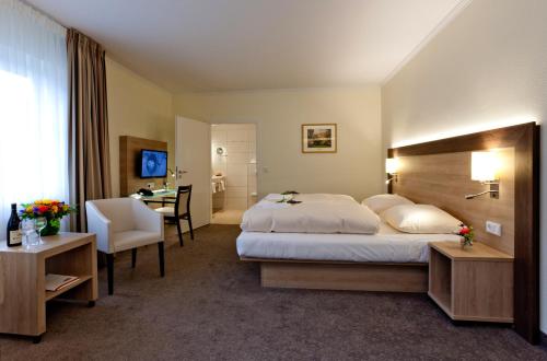 Кровать или кровати в номере Hotel Hof Sudermühlen