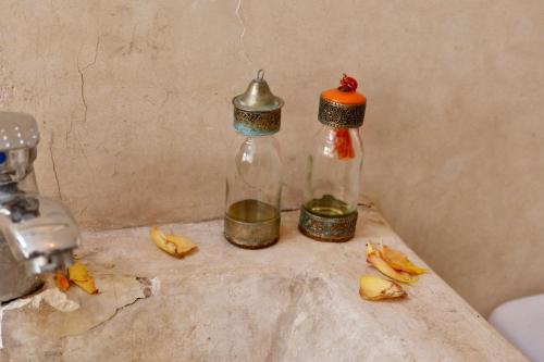 a couple of bottles sitting on a counter with bananas at house rose in Marrakech