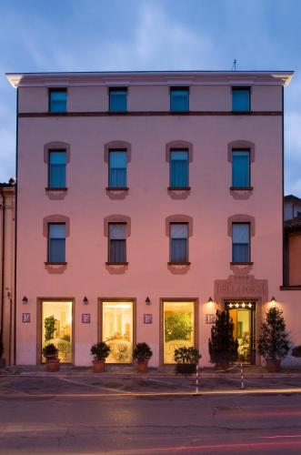 a pink building on a street at dusk at Hotel Della Porta in Santarcangelo di Romagna