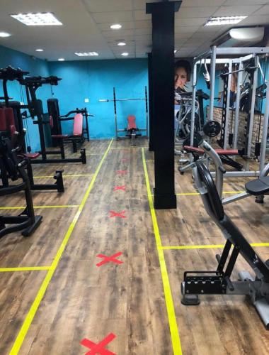 a gym with red crosses on the floor and machines at Petit Rio Hotel in Rio de Janeiro