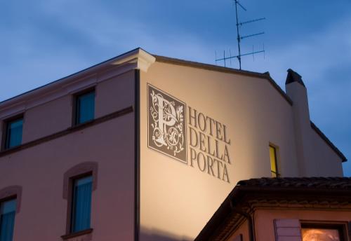 a building with a sign on the side of it at Hotel Della Porta in Santarcangelo di Romagna