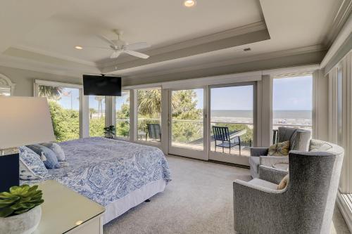 a bedroom with a bed and a view of the ocean at Oceanfront 7 BR 7 BA Wonderful Pool Deck Beach gear and bike rentals included in Hilton Head Island