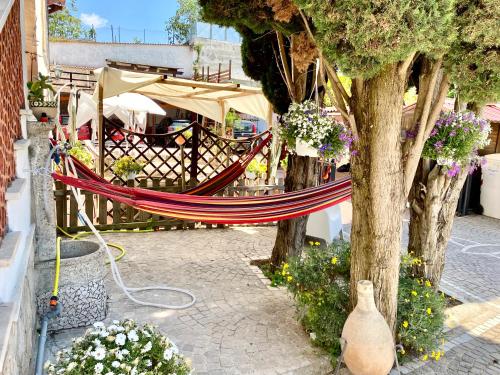 a hammock hanging from a tree next to a fence at Tabor 1 garden & parking in Naples
