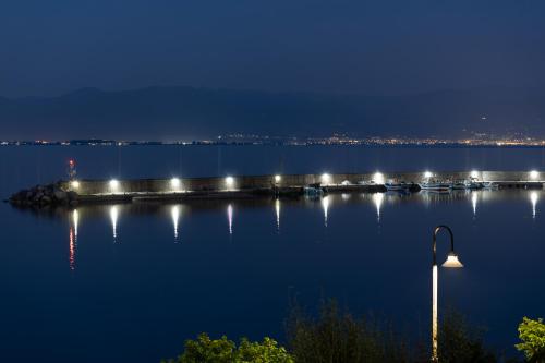 a bridge over a body of water at night at Bay View House in Petalidi