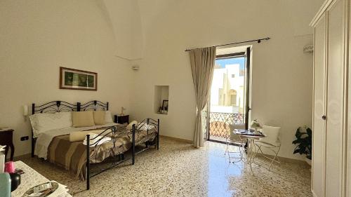 a bedroom with a bed and a balcony at camera matrimoniale centro storico Galatina in Galatina