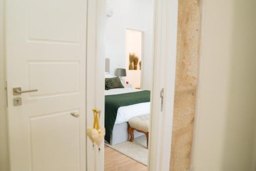 a door leading to a bedroom with a bed at Casa d'Arcã in Alijó
