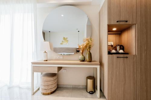 a bathroom with a vanity with a mirror at At Herbal Boutique Hotel & Spa in Protaras