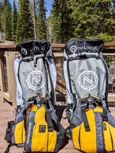 two backpacks sitting next to each other on a deck at Jackson Hole Hideout in Wilson