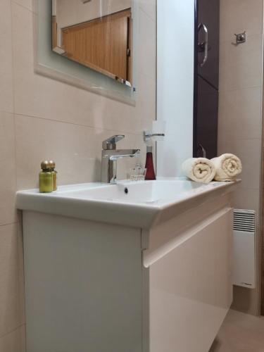 a bathroom with a white sink and a mirror at Snegar Apartments in Ohrid