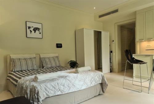 a bedroom with a bed and a table and a chair at Porto Montenegro Luxury Studio Zeta in Tivat