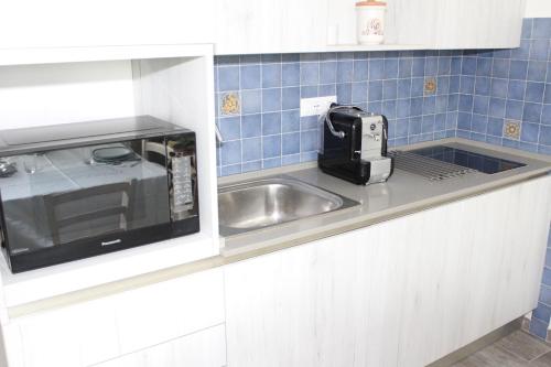 a kitchen with a sink and a toaster on a counter at Art Apartment Chianti Family in Lappeggi