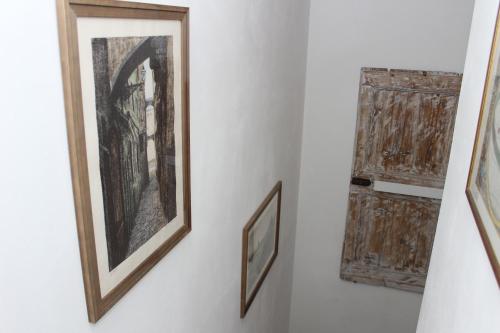 a pair of framed paintings on a wall next to a door at Art Apartment Chianti Family in Lappeggi
