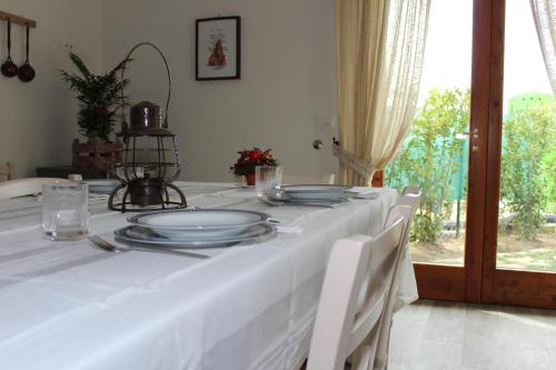 a white table with plates on top of it at Art Apartment Chianti Family in Lappeggi