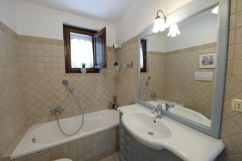 La salle de bains est pourvue d'une baignoire, d'un lavabo et d'une baignoire. dans l'établissement Dimora Monte Grappa, à Alberobello